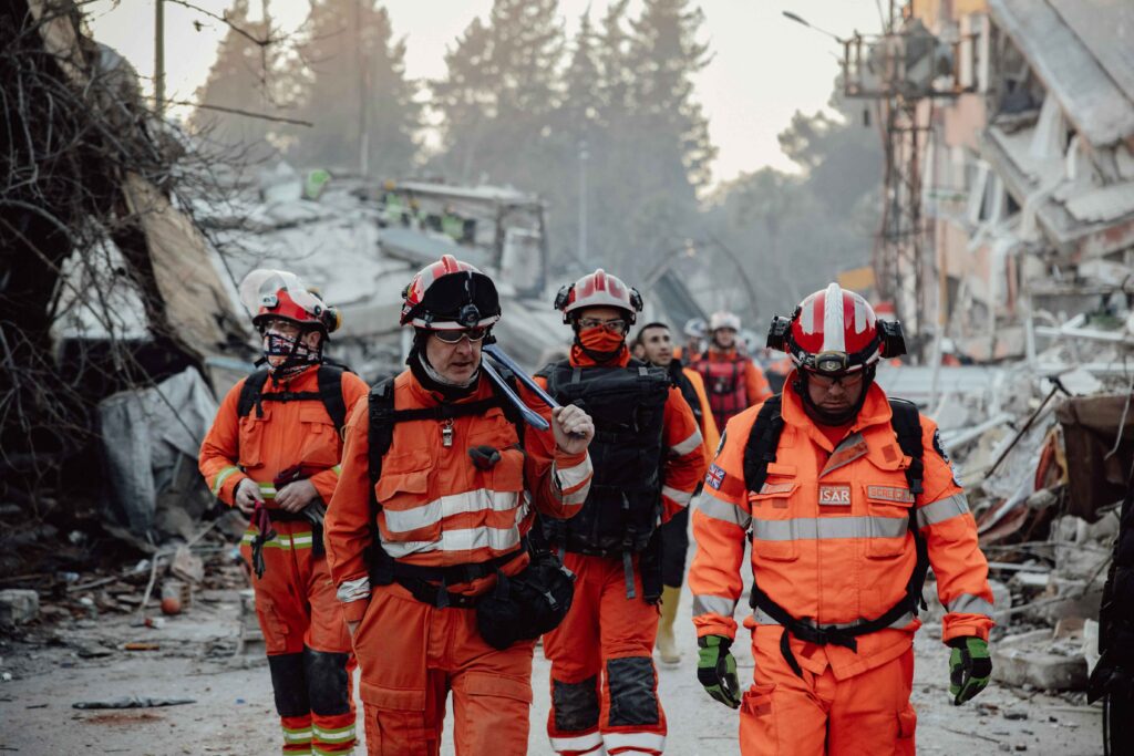 Hero image showcasing disaster relief efforts with volunteers aiding survivors